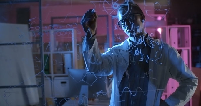 Student drawing molecular structure on glass wall in chemistry lab and young girl holding flasks