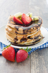 Pancakes with chocolate, strawberries and kiwi