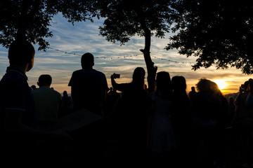 Fototapeta premium Crowd people together outdoor waiting for sunset