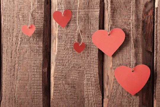 vintage red hearts on wooden background