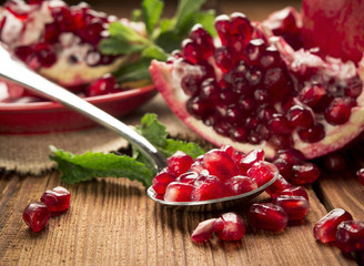 pomegranate seeds in a spoon