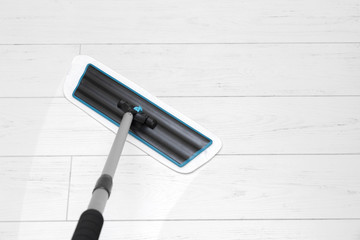 house cleaning - mop washing white laminate floor
