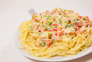 Sliced fried chicken fillet in a creamy sauce. with capellini pasta