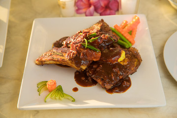 Table with food and drink for romantic dinner on sunset