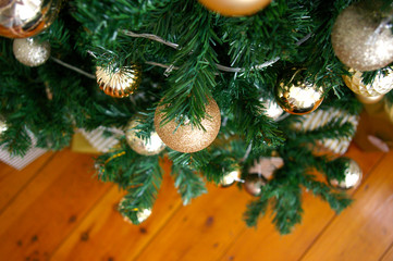 Artificial Christmas tree decorated with presents underneath