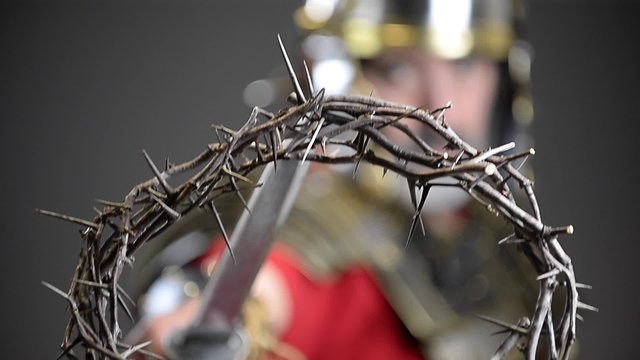 Roman soldier holding crown of thorns on tip of sword