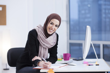Beautiful Arabic business woman working on computer. Woman in her office, shallow depth of field