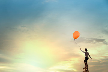 Woman reaching hand up