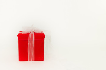 Close-up of big red gift box on white background with copyspace