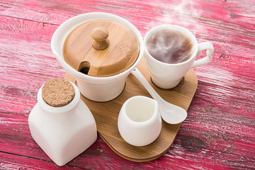 Tea cups with teapot on old wooden table