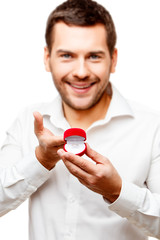 Young man presenting something in a small box