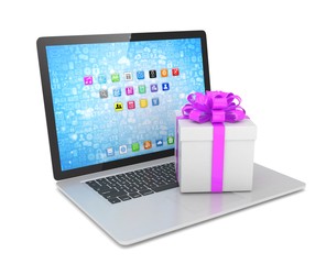 Gift box with ribbon on laptop keyboard