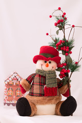 Snowman christmas toy and cottage on white background