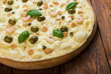Delicious seafood pizza with olives