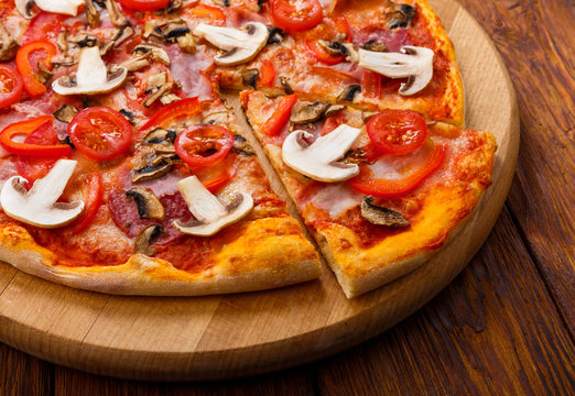 Delicious pizza with mushrooms, peppers and pepperoni