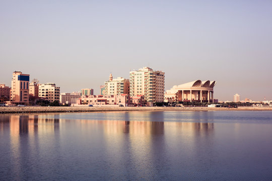 View of the arabian city from the sea with reflection, Bahrain 