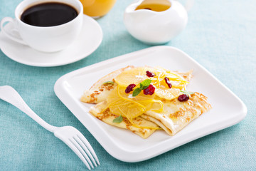 Thin crepes with citrus sauce and dried cranberry