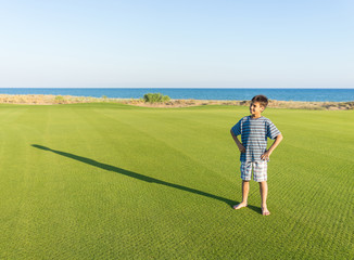 Kids with their shadows on grass