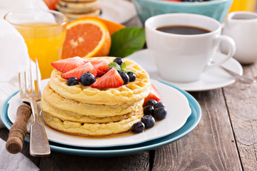 Breakfast table with stack of waffles