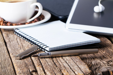 office table with notebook, computer keyboard, mouse, cup of coffee