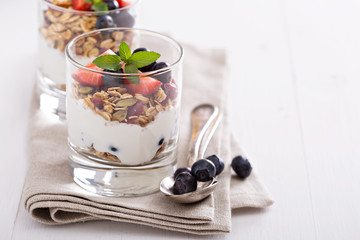 Granola with fresh berries in a blue bowl