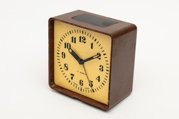 Brown square alarm clock on a white background