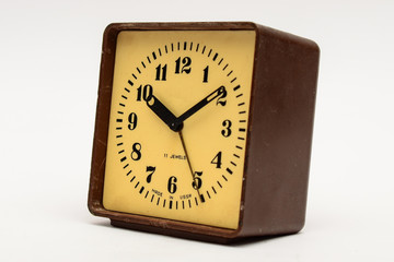 Brown square alarm clock on a white background