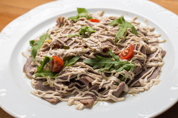 Salad with vegetables, meat on a  plate