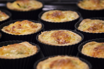 Mini quiche Lorraine - traditional French pie with ham, leeks, b