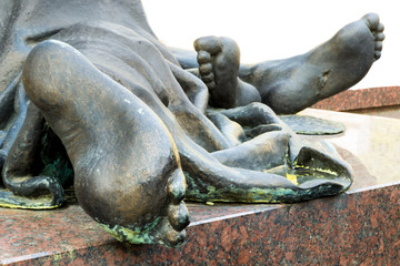 Fototapeta na wymiar Bronze feet of a statue