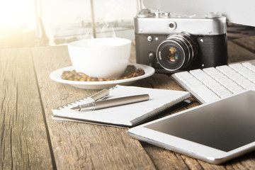 desktop of a photographer consisting on a cameras, a keyboard, a