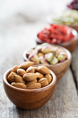 Variety of nuts and dried fruits in small bowls