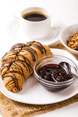 Hot cappuccino and pastries on white wooden boards
