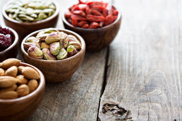 Variety of nuts and dried fruits in small bowls