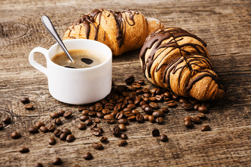 Hot cappuccino and pastries on white wooden boards