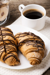 Hot cappuccino and pastries on white wooden boards