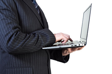 man in a suit holding a laptop