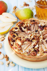 Nuts pear tart on wooden table