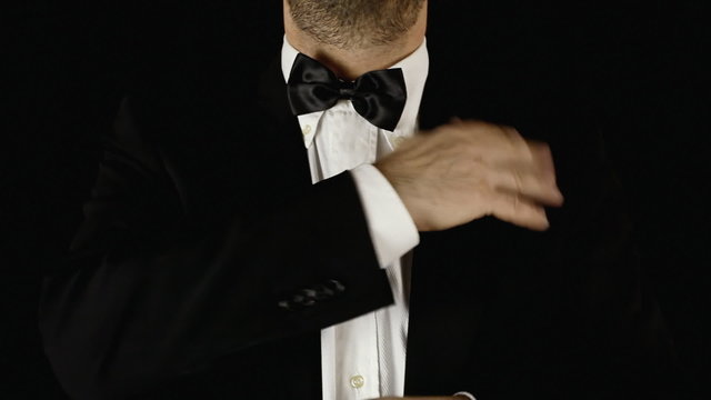 Man adjusting necktie