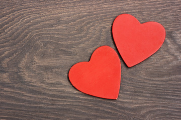Two hearts against a dark background.