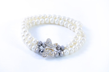 bracelet with pearls and pendants isolated on white