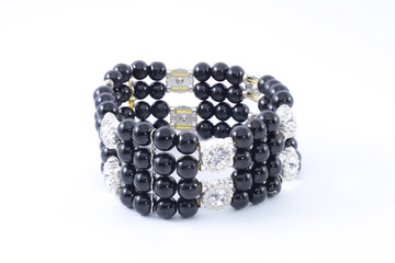Black bracelet with beads on a white background