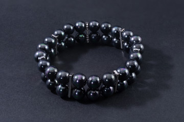 Bracelet with black pearls isolated on black