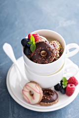 Small mini donuts in stacked coffee cups