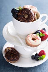 Small mini donuts in stacked coffee cups