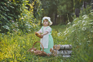 Child in a chefs costume eating a loaf of bread 4625.