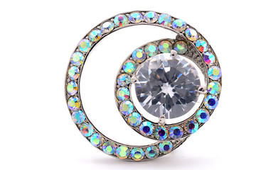 round brooch with gems on a white background