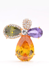 brooch with colored stones on a white background