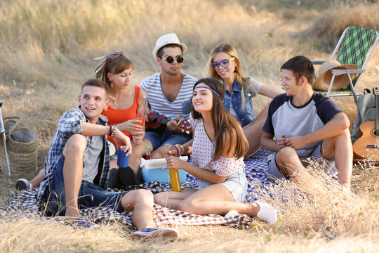 Happy friends have fun on picnic, outdoors