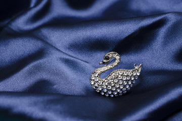 swan brooch on silk